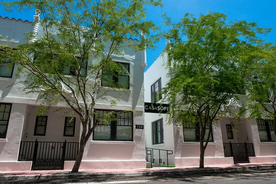 Exterior view of Casa Sofi building featuring white walls and green trees.